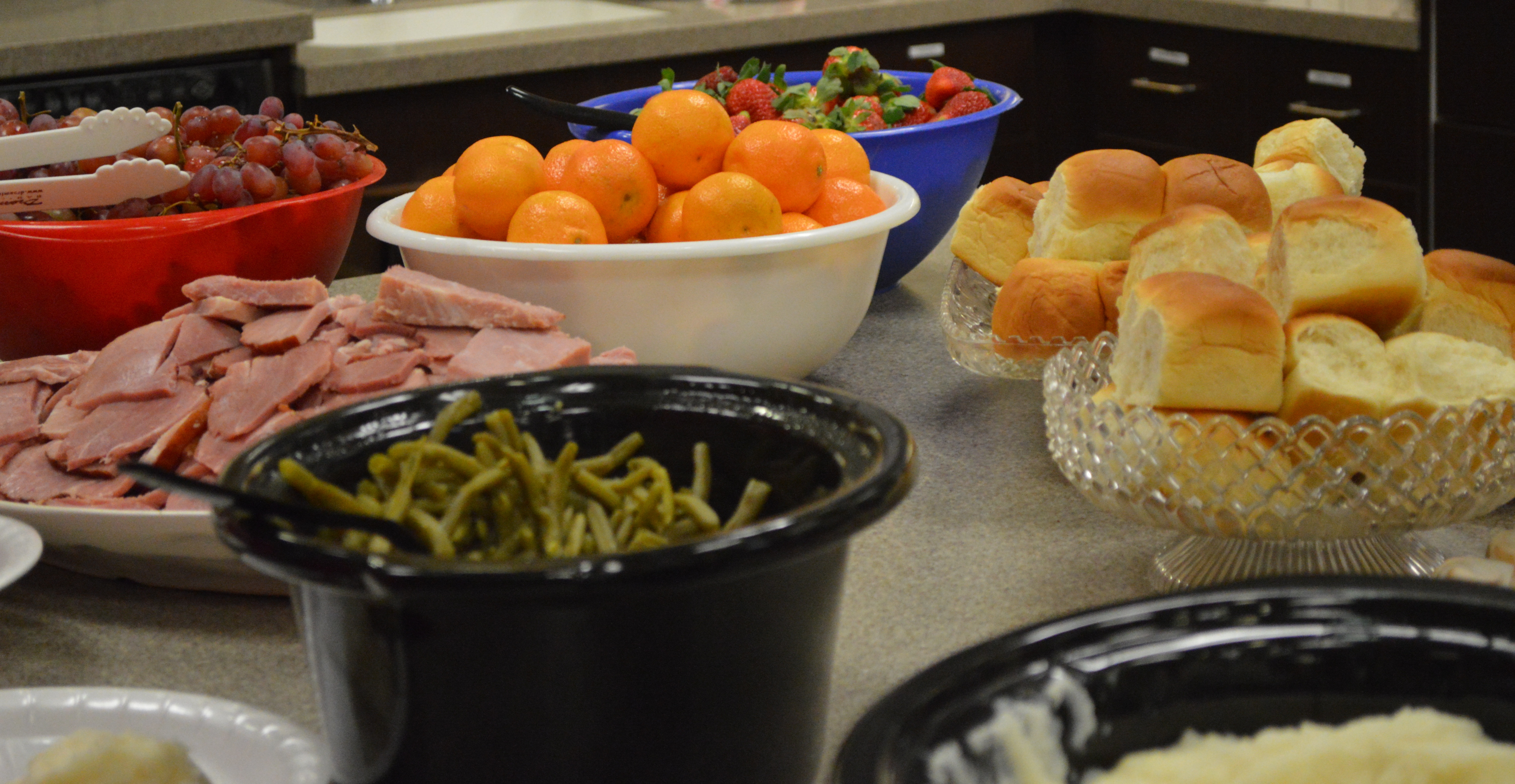 Ham, fruit, veggies and rolls complete dinner