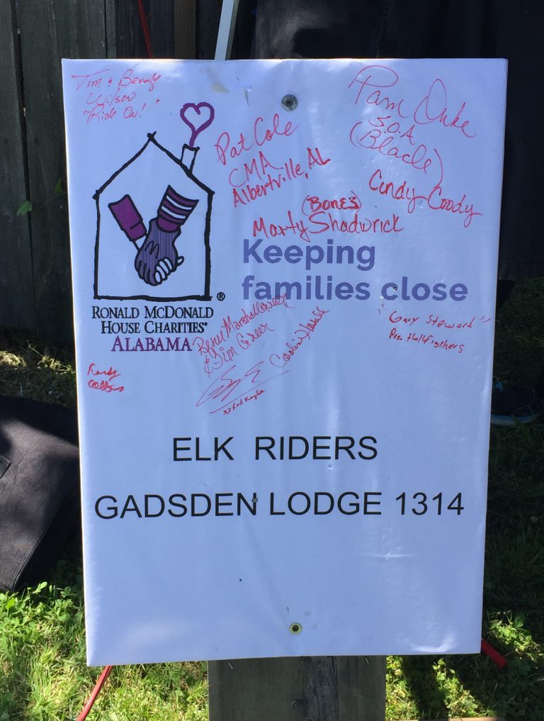 Elk Riders sign a poster supporting RMHCA