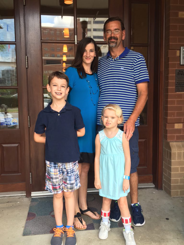Family poses in front of our House