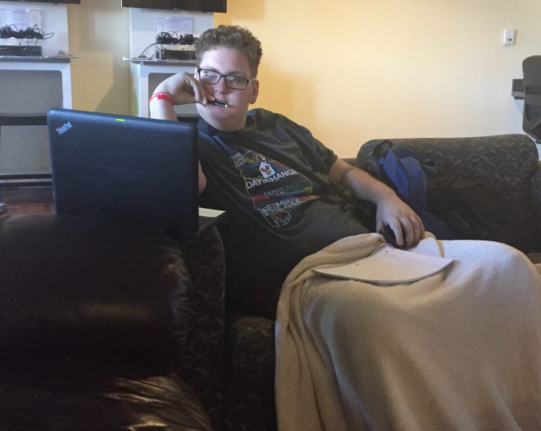 Nick busy doing his homework in the family room