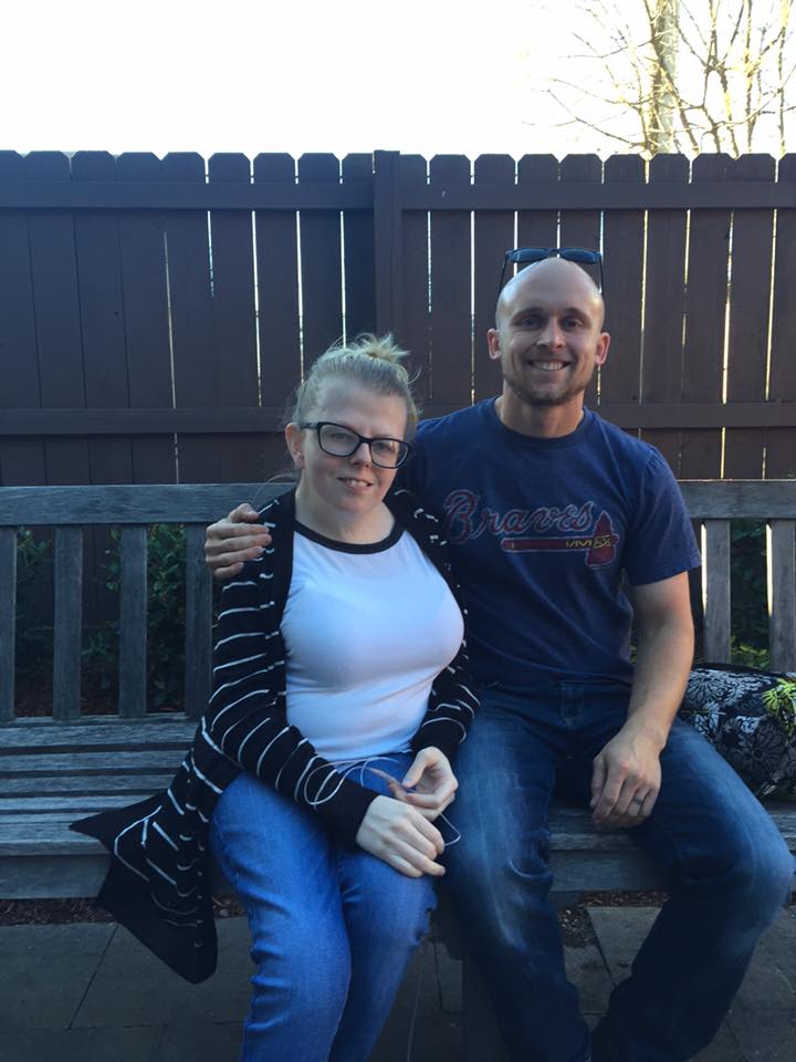 Heather and Brian pose on a bench
