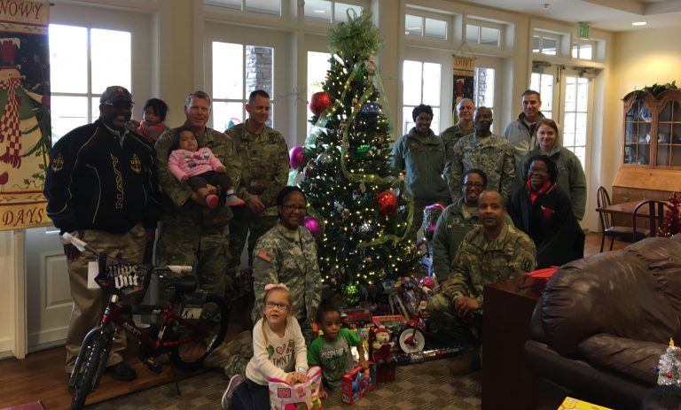 Members of the Medical Brigade bring gifts to RMHCA children
