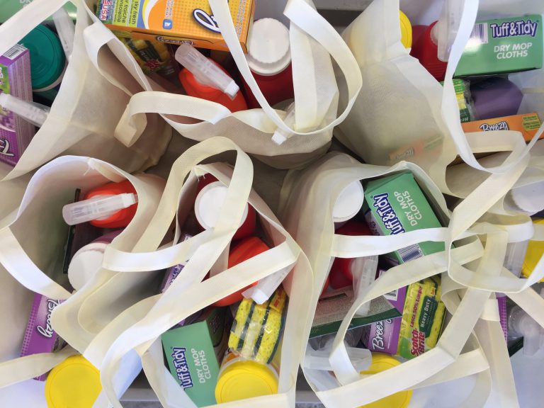 Tote bags filled with cleaning items, donated by Maynard Cooper & Gale
