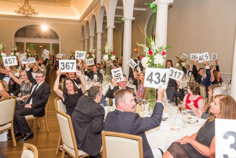 Picture of gala guests bidding during the live auction.