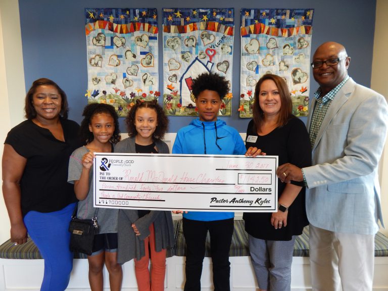 Billie joined by members of her church to present a $1,142 check to RMHCA.