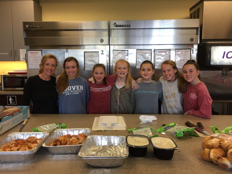 Rengering family and friends prepare a meal.