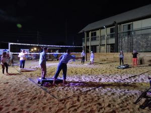 Contestants compete in the cornhole tournament.