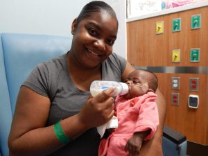 Ashley Harris feeds her daughter, E'mari.