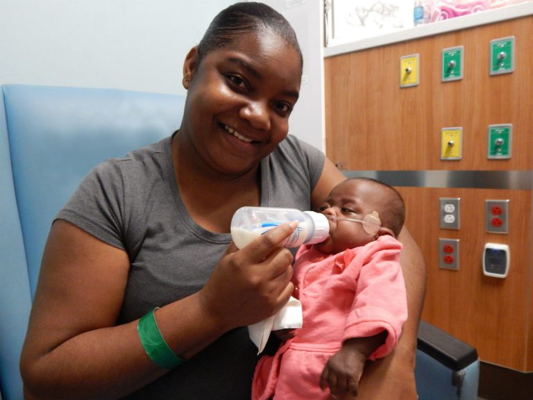 Ashley Harris feeds her daughter, E'mari.