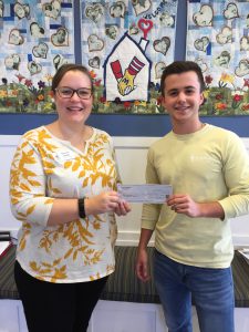 L-R: RMHCA Communications Coordinator Brianne Denley accepts a check from Alpha Tau Omega Signature Events Chairman Charles Hernly. Source: RMHCA