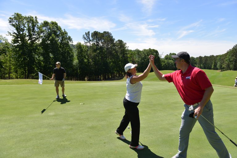Players celebrate at the 2017 Ronald McDonald House Golf Classic.