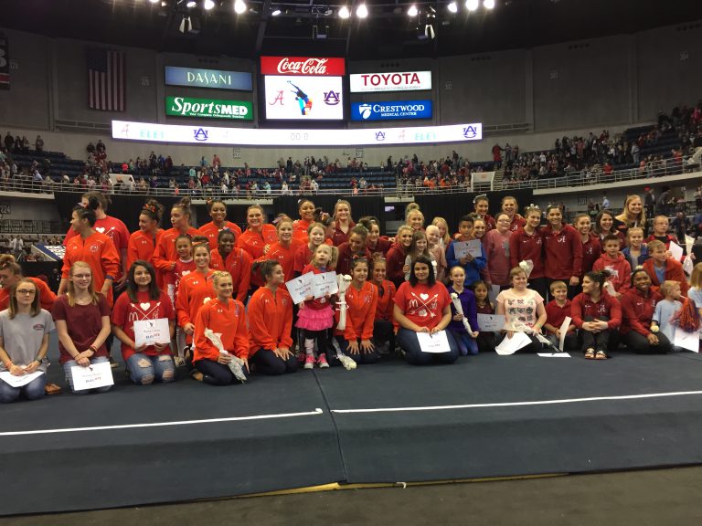 RMHCA kids sit with the Auburn gymnasts at Elevate the Stage 2018.
