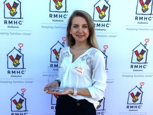 Lillie from Helena UMC poses with their volunteer award.