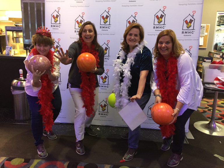 Four bowlers pose for a fun picture