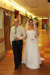 Dr. Carlo walks Rubia down the aisle. Source: University of Alabama at Birmingham