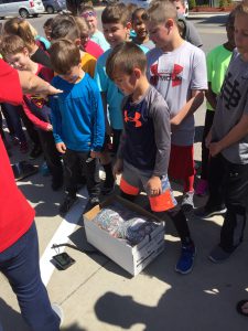 Students look on as their pop tabs are weighed for Pop Tab Pandemonium.
