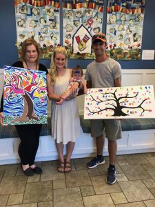Ashton, HagenKate and Cody Bond show off the paintings created by a CCHS student.
