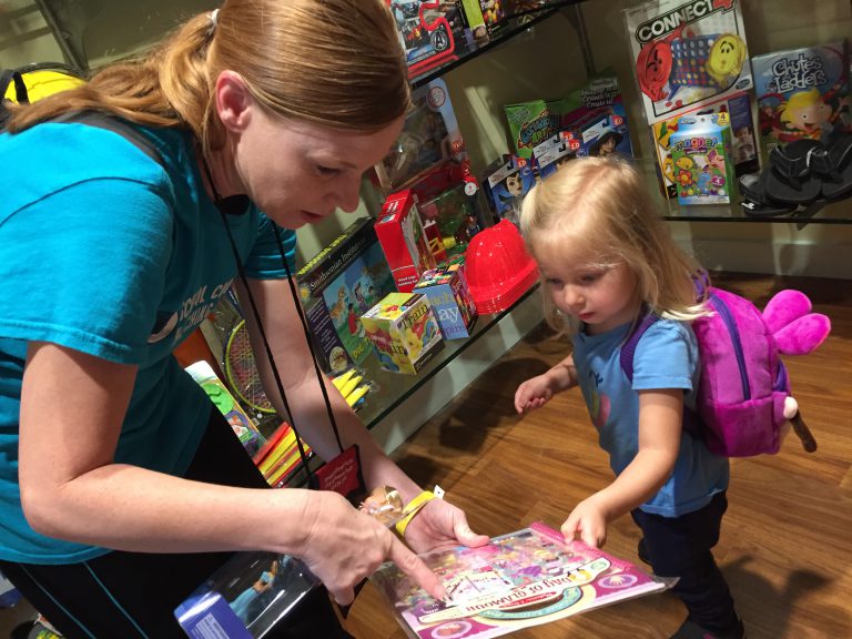 Abigail Mussi picks out a toy after achieving a medical milestone.