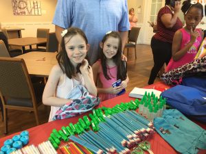 Emmalynn and Katelynn check out the school supplies donated by a local church.