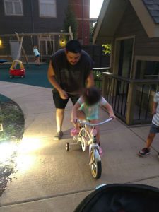 Nich teaches Addalynn to ride a bicycle. Source: Family photo