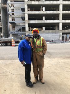 Felecia and Cleo pose in front of his work site, which is across the street from the Ronald McDonald House.