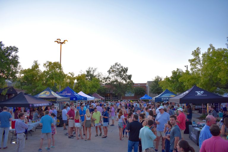People visit brewery tables to taste craft beer at Sweet Home Brews 2019.