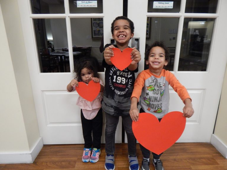Watts family siblings holding hearts