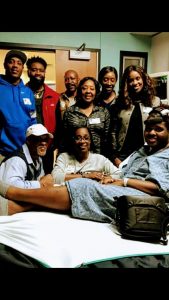 Za'Kelby's family visits him in the hospital.