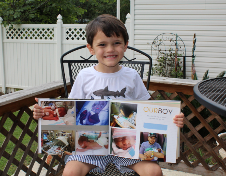 Young boy holds a photo album