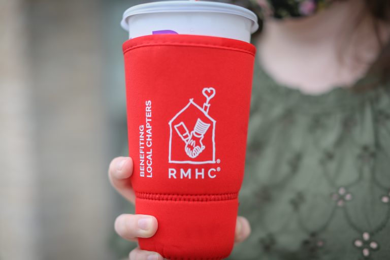 A woman holds up a Sleeve for Support