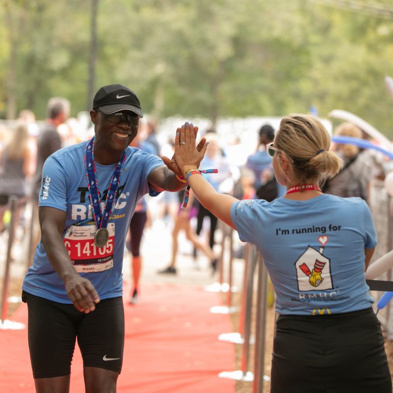 A woman high fives a runner
