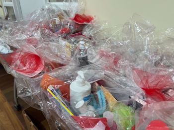 care baskets filled with toiletries, activity books and cards with encouraging notes