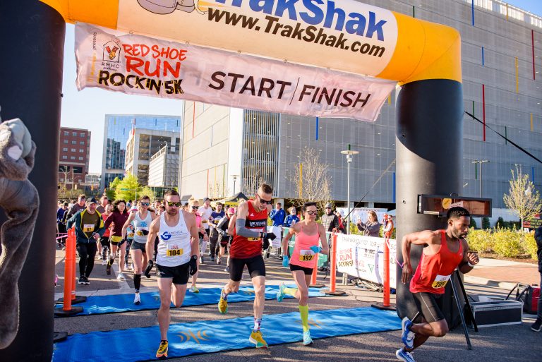 Runners take off from the start line at Red Shoe Run: Rockin' 5K