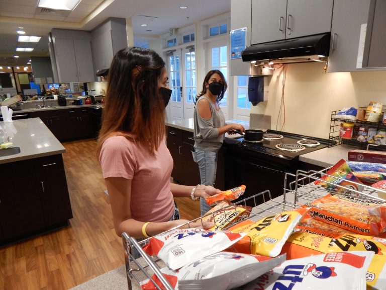a teen and her mom in a kitchen