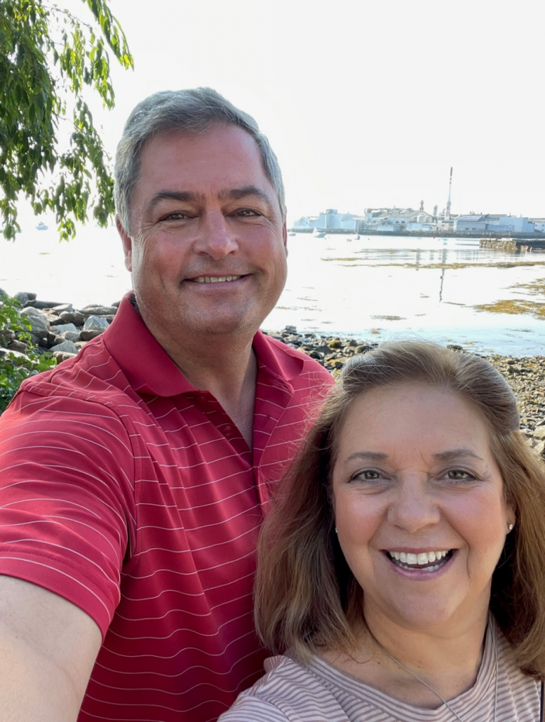 A man and a woman pose together for a photo