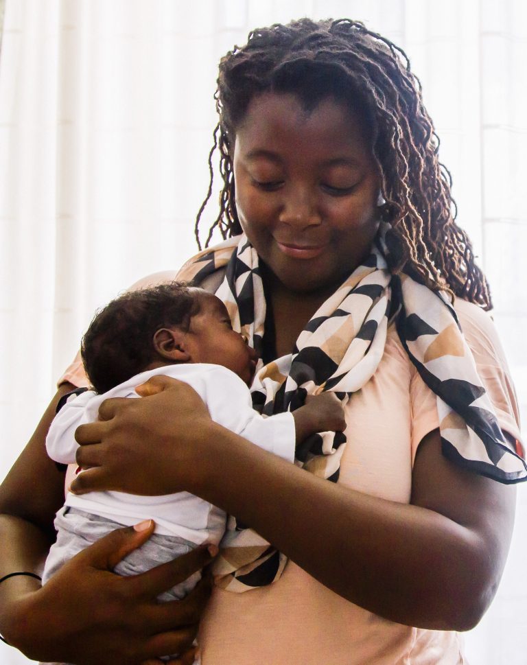 A mother holds her infant