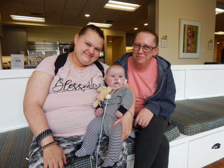 A mom holds her infant son