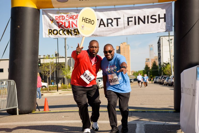 Two men cross a finish line