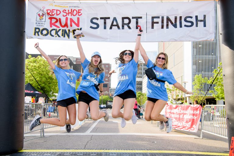 Four women jump at the start line