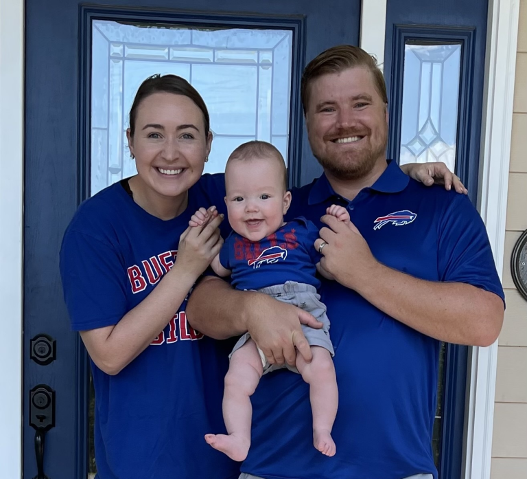 A mother and father hold their infant son