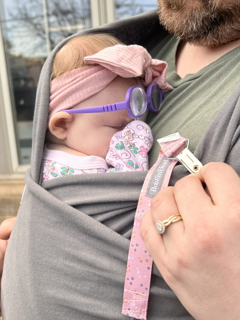 A baby with a pink bow