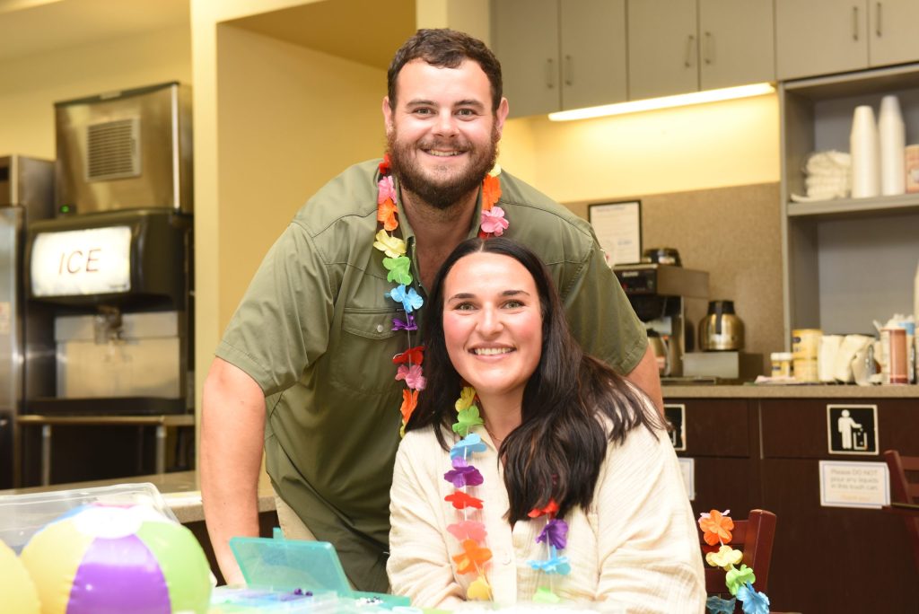 A man and a woman pose for a photo