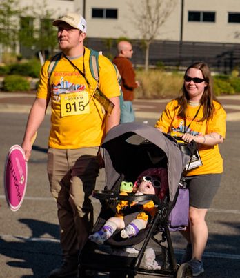 A family crosses the finish line at a fun run