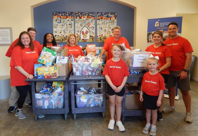 A group of men and women donating wish list items