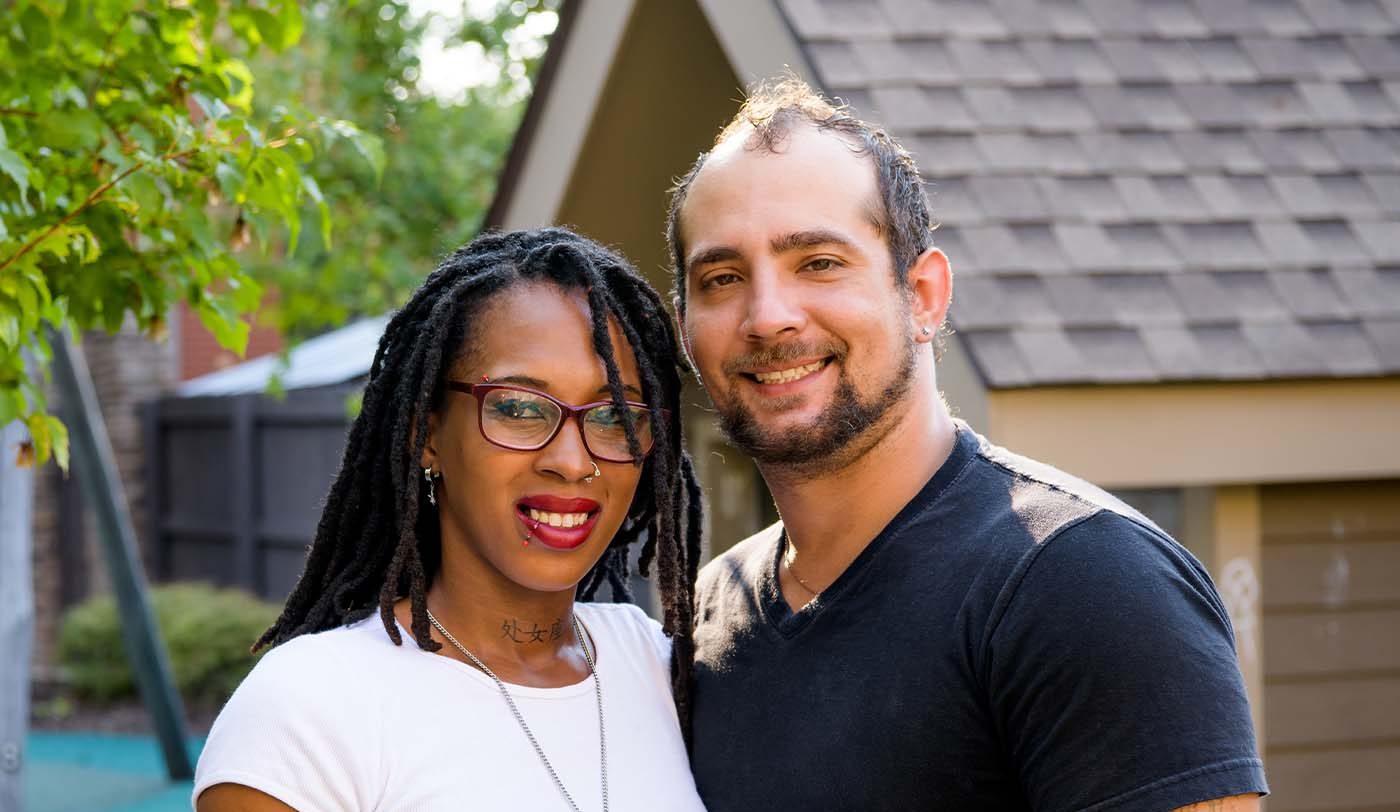 A woman and man pose for a photo