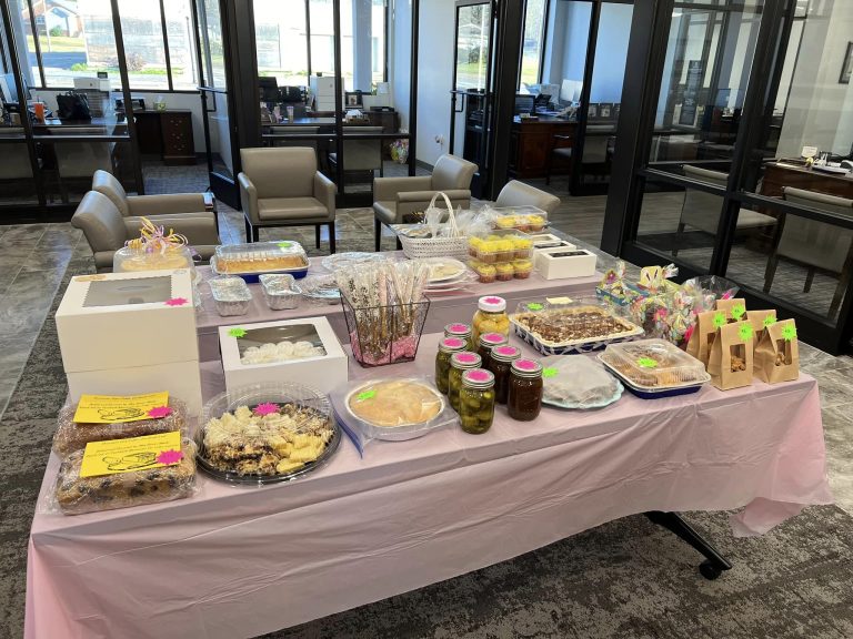 A table covered in baked goodies like cake and cookies
