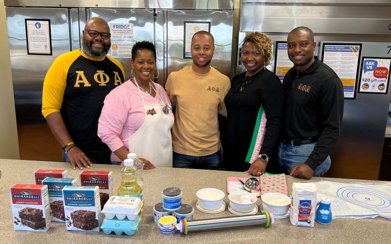 Group volunteers posing in the RMHCA kitchen