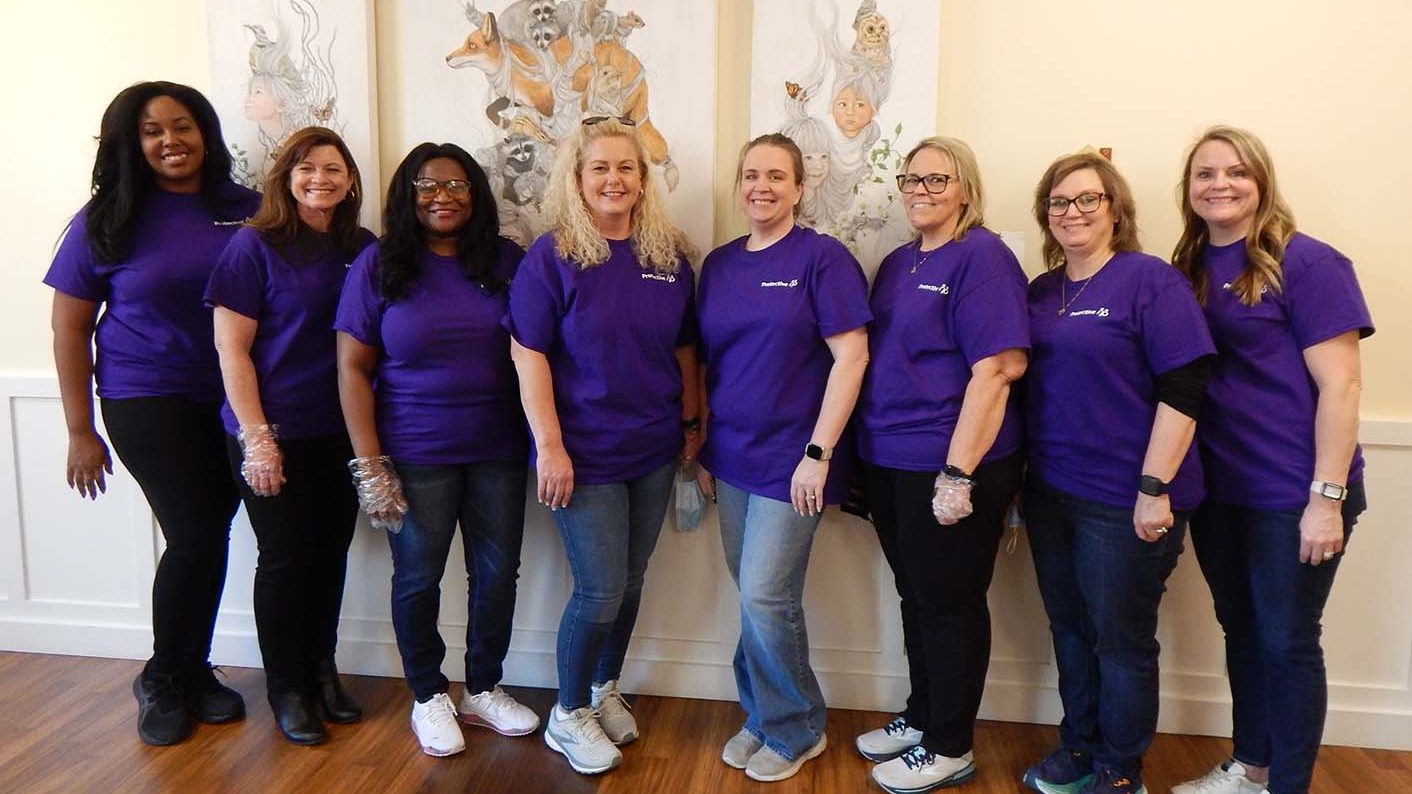 8 Protective employees posing for a picture
