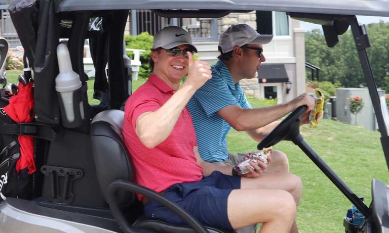 Two golfers in a golf cart