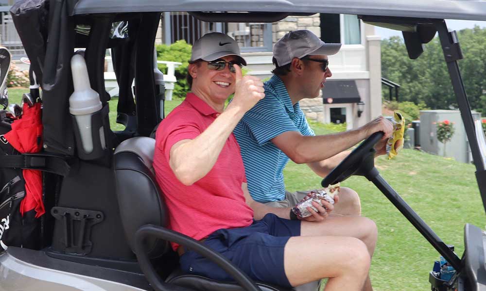 Two golfers in a golf cart